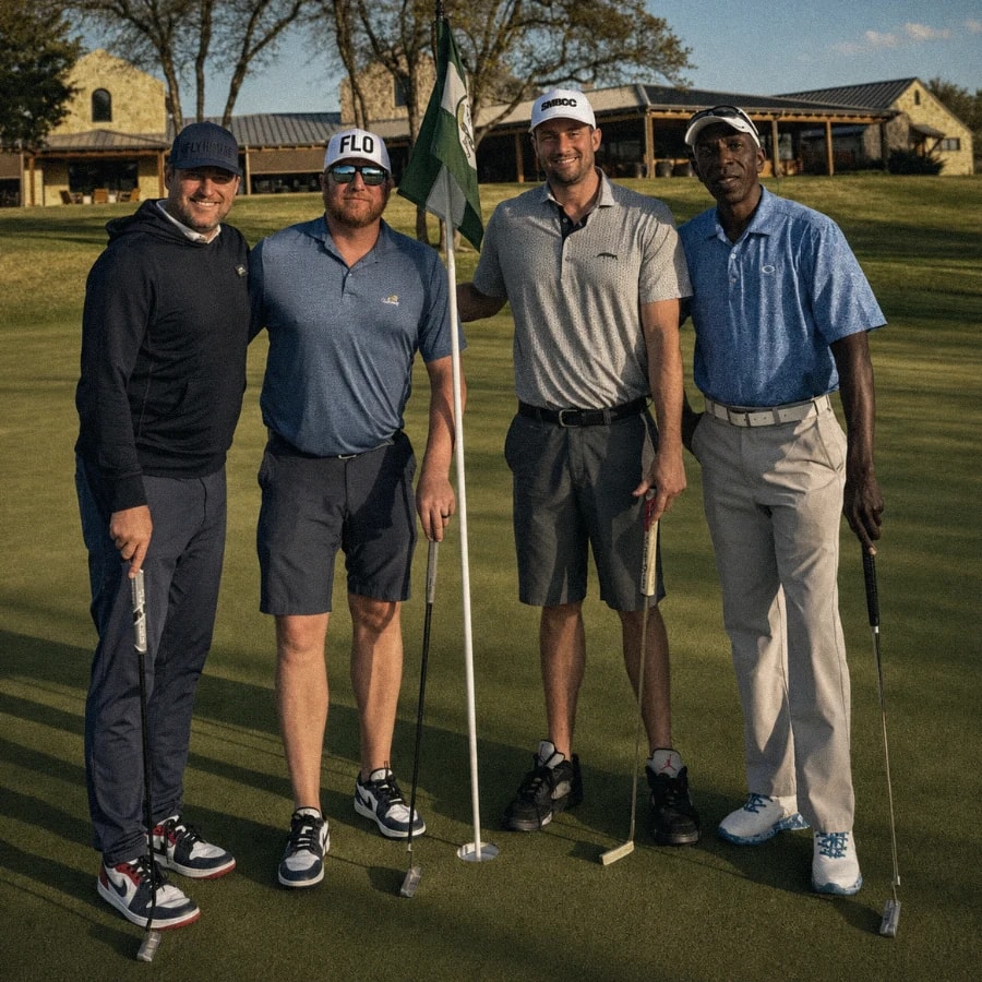 A foursome on the green with the clubhouse behind